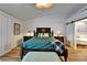 This well-lit main bedroom offers a queen-size bed, walk-in closet and a view of the main bathroom at 743 Kingston Ct, Apollo Beach, FL 33572