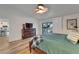 The main bedroom features a queen-size bed, a television, and access to the screened patio at 743 Kingston Ct, Apollo Beach, FL 33572