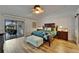 This beautiful main bedroom features hardwood floors and a view of the screened patio with a tiki bar at 743 Kingston Ct, Apollo Beach, FL 33572