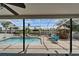 Relaxing screened-in pool and patio area with tiki bar is perfect for entertaining and enjoying waterfront views at 743 Kingston Ct, Apollo Beach, FL 33572