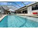 Perfect for entertaining or relaxing, enjoy the backyard pool and patio of this Florida home with comfortable lounge chairs at 743 Kingston Ct, Apollo Beach, FL 33572