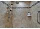 A detailed view of a shower with decorative tile, a shower head and controls, and shampoo and conditioner bottles at 743 Kingston Ct, Apollo Beach, FL 33572