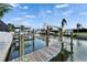 Serene waterfront dock scene featuring boat lifts and calm canal waters at 743 Kingston Ct, Apollo Beach, FL 33572