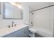 Bright bathroom featuring a gray vanity, hexagon tile shower, and a chrome faucet at 7763 Jenner Ave, New Port Richey, FL 34655