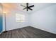 Another view of this bedroom featuring a large window and modern ceiling fan at 7763 Jenner Ave, New Port Richey, FL 34655