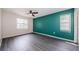Comfortable bedroom with modern flooring, complemented by natural light from two windows at 7763 Jenner Ave, New Port Richey, FL 34655