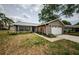 Charming single-story home with brick accents, attached garage, and a cozy landscaped front yard at 7763 Jenner Ave, New Port Richey, FL 34655