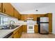 Functional kitchen featuring stainless steel appliances, ample cabinet space, and a bright, clean design at 7763 Jenner Ave, New Port Richey, FL 34655