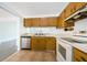Functional kitchen with stainless steel dishwasher and traditional wooden cabinets at 7763 Jenner Ave, New Port Richey, FL 34655