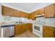 Well-lit kitchen with stainless steel dishwasher and classic cabinetry at 7763 Jenner Ave, New Port Richey, FL 34655