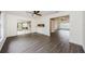 Open living space with gray floors, a fan, and seamless transition to a screened outdoor area at 7763 Jenner Ave, New Port Richey, FL 34655