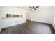 Bright living room with modern gray flooring and an open view into the kitchen at 7763 Jenner Ave, New Port Richey, FL 34655