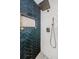 Detailed view of a stylish shower with blue herringbone tile, niche and shower head at 7763 Jenner Ave, New Port Richey, FL 34655