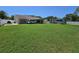 Spacious backyard featuring well-maintained lawn, RV parking, and fenced perimeter at 827 Creekside Ln, Palm Harbor, FL 34684