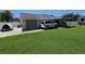Spacious backyard with green lawn, covered patio, and garage access, ideal for outdoor living at 827 Creekside Ln, Palm Harbor, FL 34684