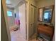 Clean, well-lit bathroom with tiled floor, tub/shower combination, and closet for storage at 827 Creekside Ln, Palm Harbor, FL 34684