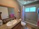 Traditional bathroom with tub, shower, window, and vanity featuring a white sink at 827 Creekside Ln, Palm Harbor, FL 34684