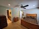 Comfortable bedroom featuring neutral walls, ceiling fan and en-suite bathroom at 827 Creekside Ln, Palm Harbor, FL 34684