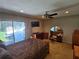 Comfortable bedroom featuring neutral walls, ceiling fan and sliding glass door at 827 Creekside Ln, Palm Harbor, FL 34684