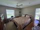 Bedroom with ceiling fan, closet, and window providing bright natural light at 827 Creekside Ln, Palm Harbor, FL 34684