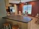 Bright kitchen with granite countertops, stainless appliances, and eat-in breakfast bar with seating at 827 Creekside Ln, Palm Harbor, FL 34684