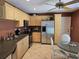 Well-appointed kitchen with stainless steel appliances, light wood cabinets, and a cozy dining area at 827 Creekside Ln, Palm Harbor, FL 34684
