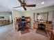Spacious office area with ceiling fan, large windows, and a built-in desk at 827 Creekside Ln, Palm Harbor, FL 34684