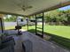 View of a covered patio with ceiling fan, outdoor furniture, and an RV parked in the backyard at 827 Creekside Ln, Palm Harbor, FL 34684