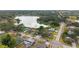 An aerial view showcases the neighborhood setting near a serene lake and tree-lined streets at 916 Shangri La Dr, Seffner, FL 33584