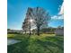 Beautifully maintained backyard featuring lush green grass and mature trees with lake views at 916 Shangri La Dr, Seffner, FL 33584