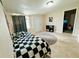 A cozy bedroom features a checkered bedspread, modern flooring, and plenty of natural light at 916 Shangri La Dr, Seffner, FL 33584