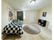 A cozy bedroom features a checkered bedspread, modern flooring, and plenty of natural light at 916 Shangri La Dr, Seffner, FL 33584