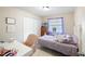 Bright bedroom featuring a bed, desk, and closet space with a window for natural light at 916 Shangri La Dr, Seffner, FL 33584