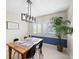 Bright dining room features a wood table, black chairs, and modern light fixture at 916 Shangri La Dr, Seffner, FL 33584