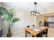 Charming dining area with a wooden table, modern lighting, and ample natural light at 916 Shangri La Dr, Seffner, FL 33584