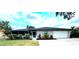 Charming single story home with stone accents, a screened porch, and attached one car garage at 916 Shangri La Dr, Seffner, FL 33584