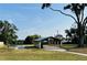 Community pavilion available to residents, with picnic tables and paved walkway to the lake in the distance at 916 Shangri La Dr, Seffner, FL 33584