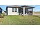 Home exterior showing a screened in porch and a well-maintained lawn at 9474 Shorebird Ct, Parrish, FL 34219