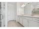 Bathroom showcasing a double vanity with white cabinetry and a glass-enclosed shower at 9474 Shorebird Ct, Parrish, FL 34219