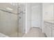 Bathroom features a tiled shower with glass door and a white vanity with storage at 9474 Shorebird Ct, Parrish, FL 34219
