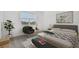 Comfortable bedroom featuring a cozy bed, accent chair, and ample natural light, creating a serene and inviting space at 9474 Shorebird Ct, Parrish, FL 34219