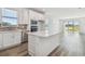Bright kitchen with white cabinets, stainless steel appliances, large island, and an open layout for easy entertaining at 9474 Shorebird Ct, Parrish, FL 34219