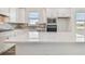 Beautiful kitchen featuring white cabinets, stainless steel appliances, and a spacious island perfect for meal preparation at 9474 Shorebird Ct, Parrish, FL 34219