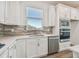 Modern kitchen featuring stainless steel appliances, stylish backsplash, and white cabinetry for a bright, clean look at 9474 Shorebird Ct, Parrish, FL 34219