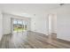 Bright living room features wood-look floors and sliding glass doors leading to an outdoor area at 9474 Shorebird Ct, Parrish, FL 34219