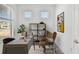 Stylish home office with a sleek desk, modern shelving, and a comfortable armchair, perfect for productivity at 9474 Shorebird Ct, Parrish, FL 34219