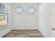 Home office space with wood-look floors and two windows offering natural light at 9474 Shorebird Ct, Parrish, FL 34219