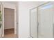 Bright bathroom featuring a glass-enclosed shower and a doorway to a walk-in closet at 9947 Trellis Vine Way, Parrish, FL 34219