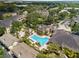 Community aerial showcasing pool with lounge chairs, manicured landscaping and elegant residential buildings at 10203 Courtney Palms Blvd # 301, Tampa, FL 33619