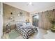 Stylish bedroom with decorative wood wall, light floors, and a barn-door closet at 10203 Courtney Palms Blvd # 301, Tampa, FL 33619